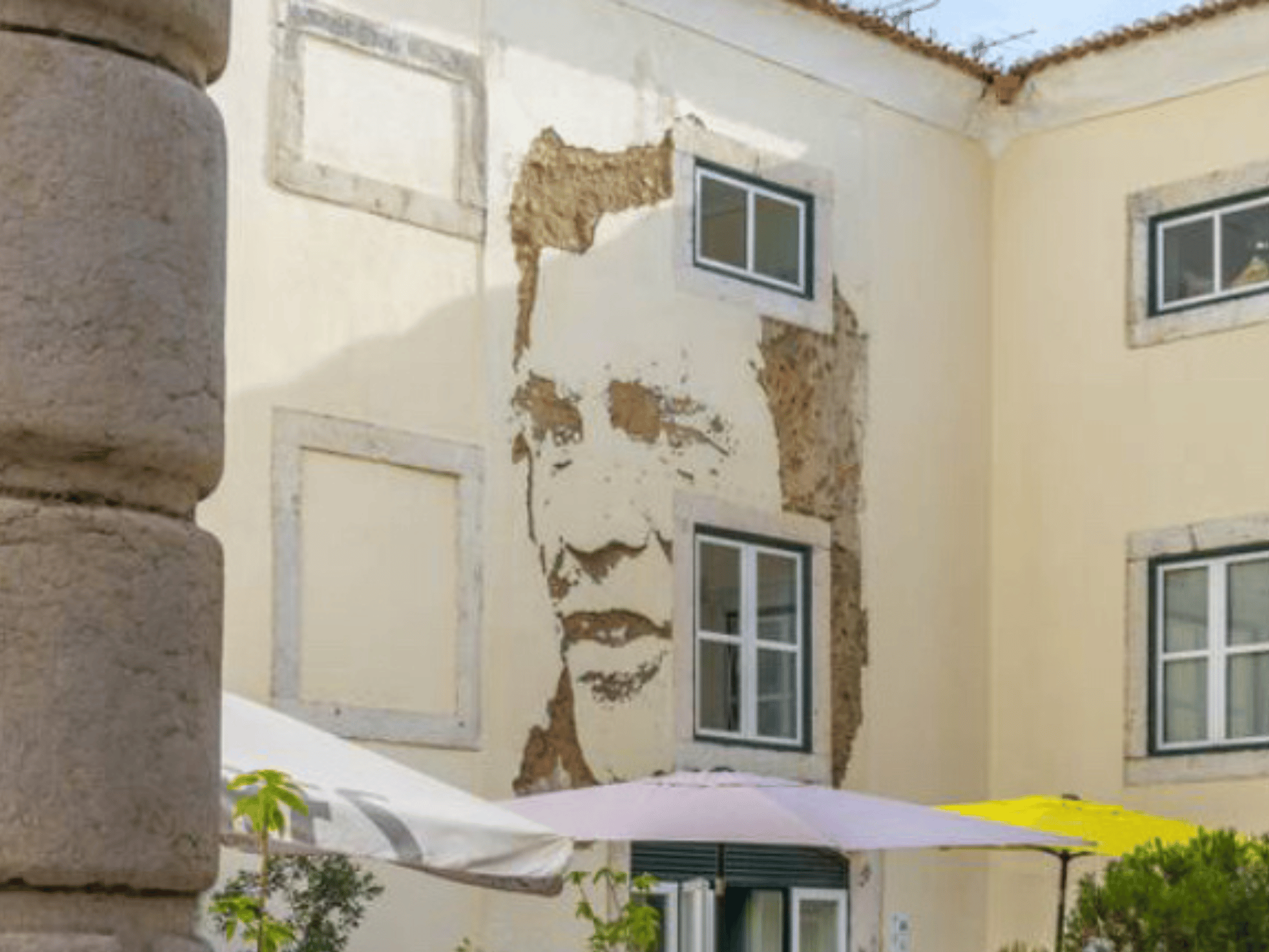 Street art Tour, mural with layered textures by Vhils at LX Factory, Lisbon